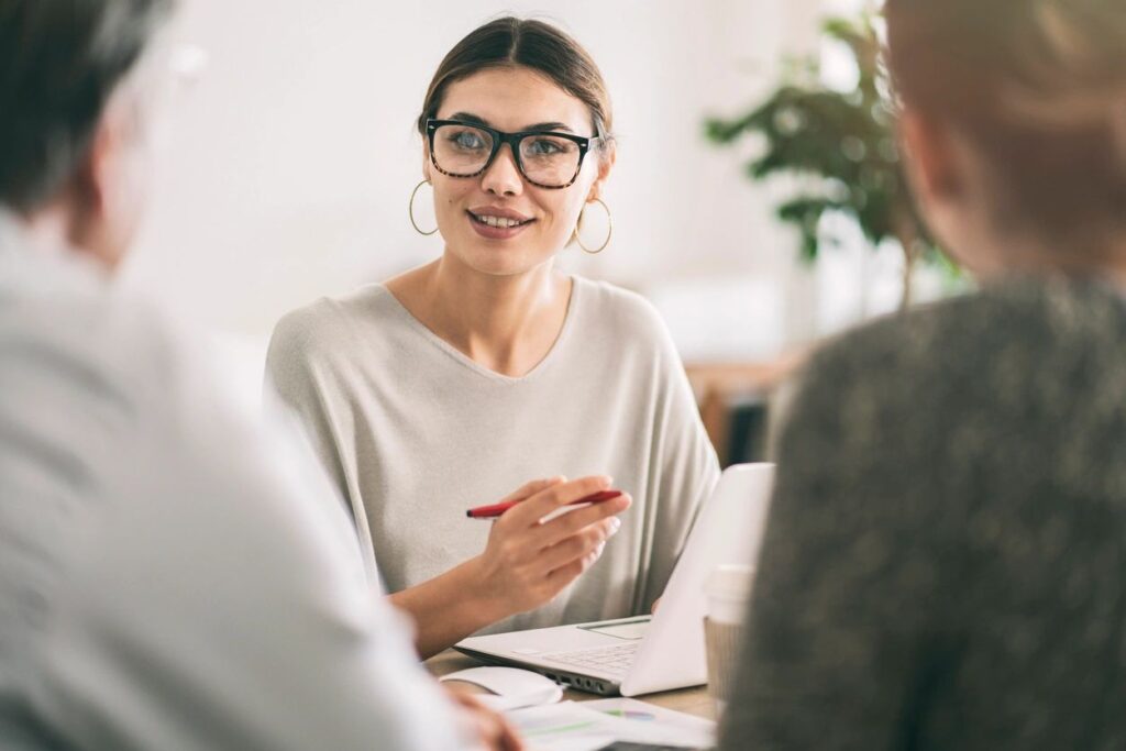 Smiling woman with glasses advising clients