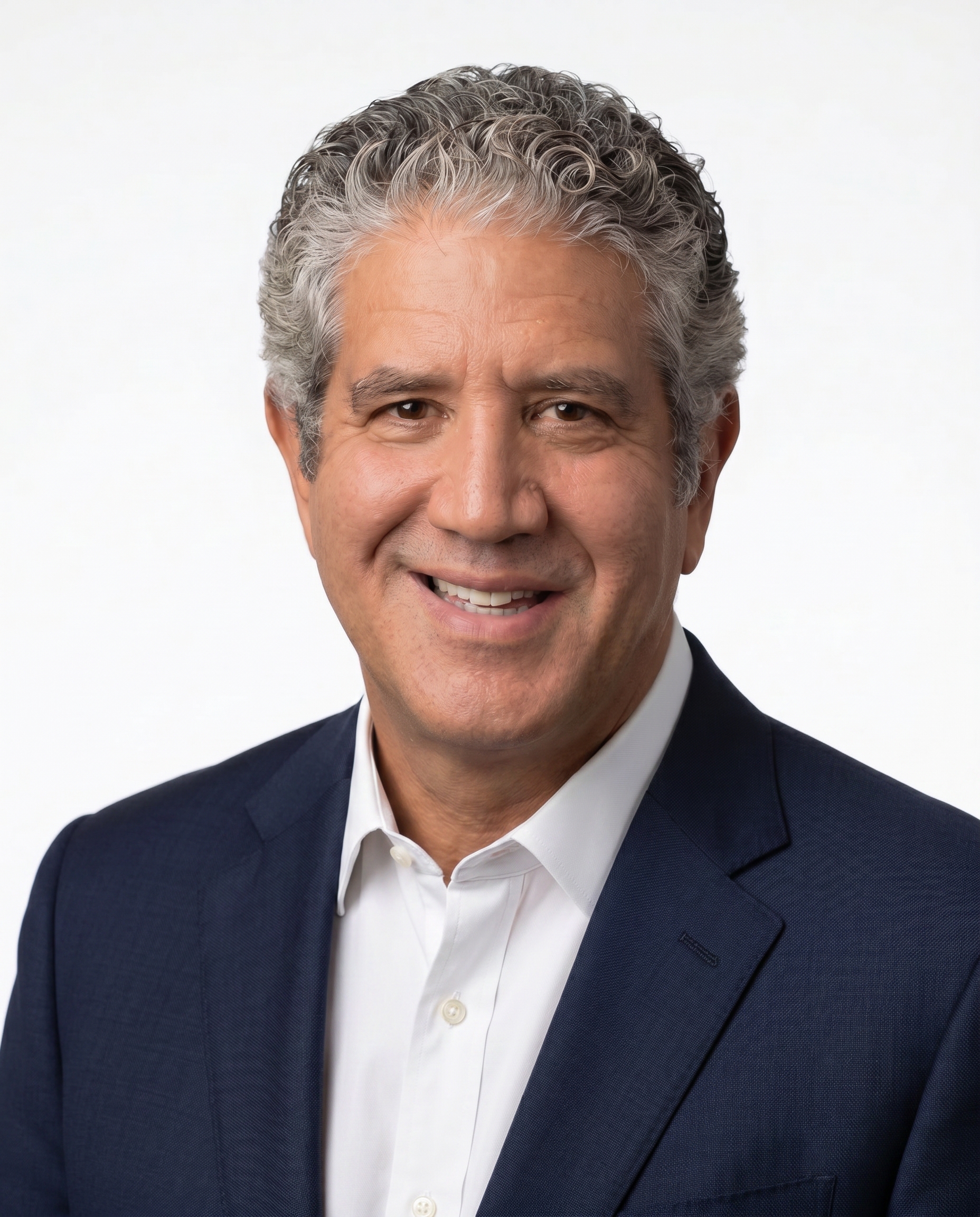 Professional headshot of smiling man in navy suit